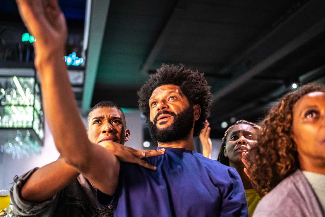 Football fans arguing in a viewing hall