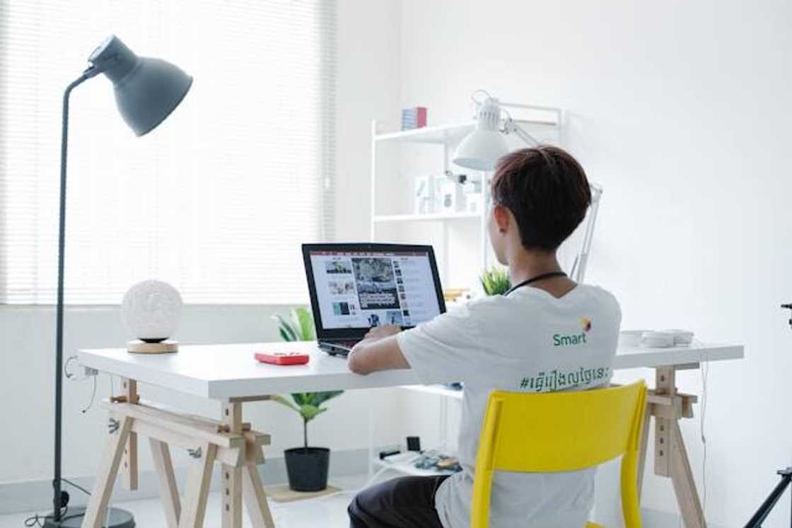 A young person working on a laptop