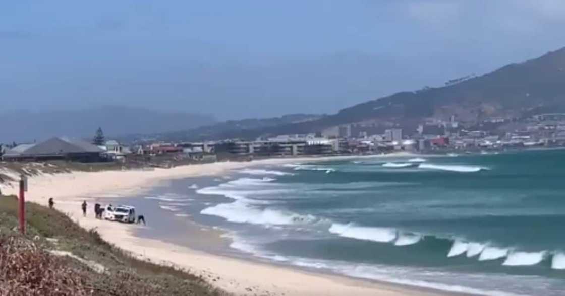 Clip shows cops hard at work moving a van stuck on beach as tide rises