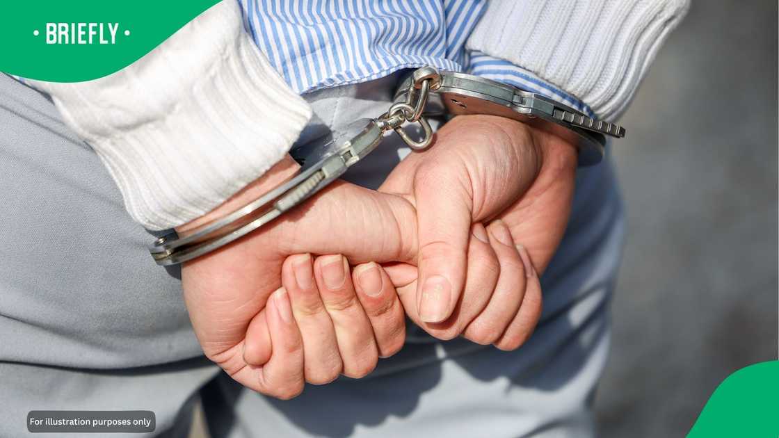 A man in cuffs. A man in cuffs.