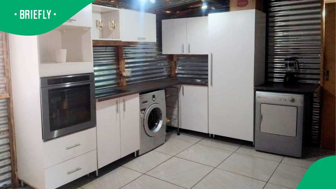 A woman showed off her shack's kitchen. A woman showed off her shack's kitchen.