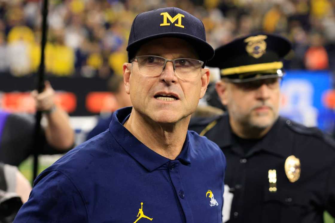 Jim Harbaugh of the Michigan Wolverines walks on the field after winning the Big Ten Championship Jim Harbaugh of the Michigan Wolverines walks on the field after winning the Big Ten Championship