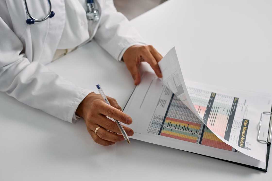 Doctor reviewing medical test results on a clipboard.