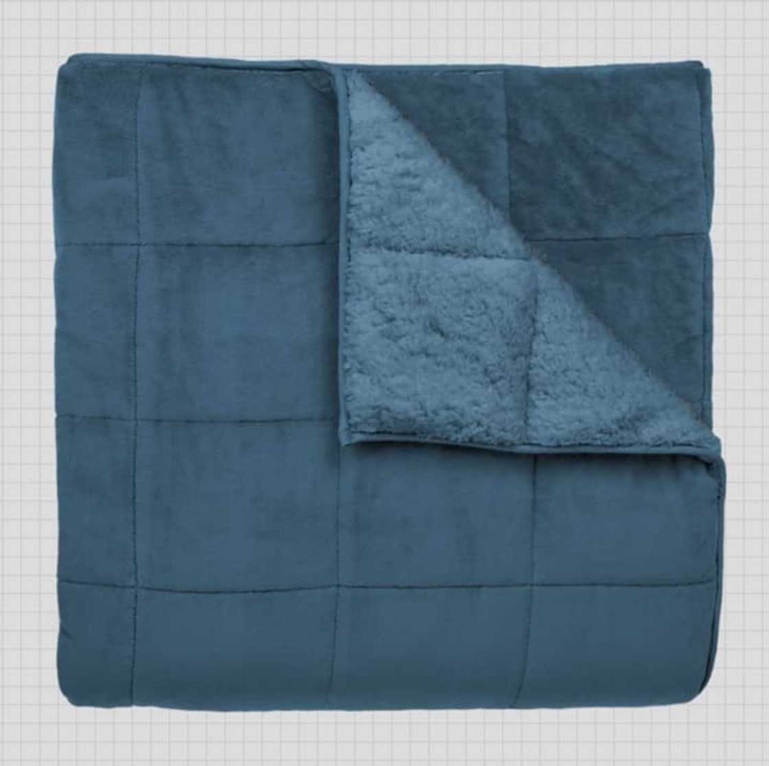 A green gravity weighted blanket A green gravity weighted blanket