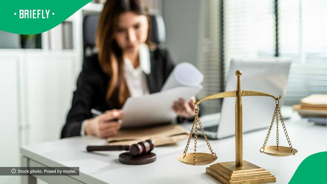 A lawyer seated behind a table. A lawyer seated behind a table.