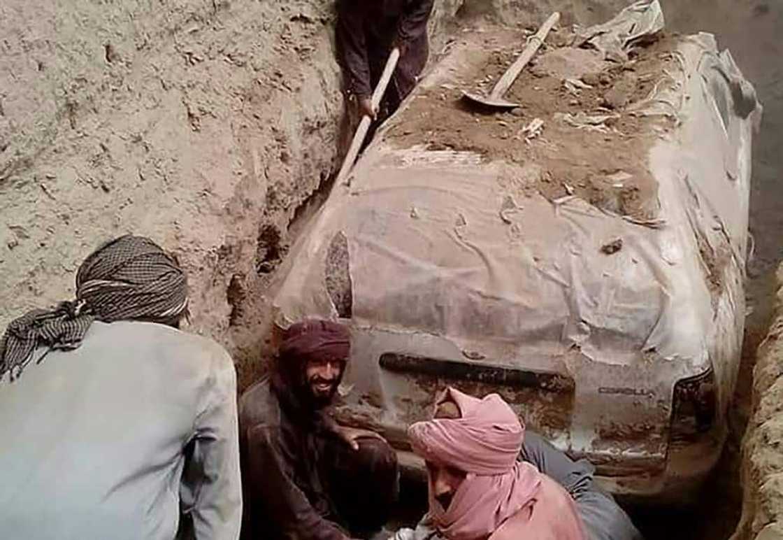The white Toyota Corolla was buried in a village garden in Zabul province by Taliban official Abdul Jabbar Omari, who ordered it to be dug up this week.
In this undated handout picture released by Taliban media officials on July 7, 2022, Taliban members dig up a Toyota Corolla, used by Taliban founder Mullah Omar to escape being targetted by US forces after 9/11, at Omrazai village in Seyora district of Zabul province. The white Toyota Corolla was buried in a village garden in Zabul province by Taliban official Abdul Jabbar Omari, who ordered it to be dug up this week.
In this undated handout picture released by Taliban media officials on July 7, 2022, Taliban members dig up a Toyota Corolla, used by Taliban founder Mullah Omar to escape being targetted by US forces after 9/11, at Omrazai village in Seyora district of Zabul province.