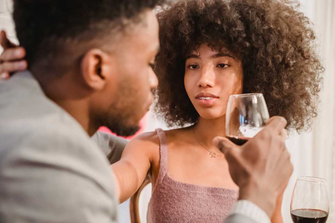 A couple sharing wine and a personal conversation. A couple sharing wine and a personal conversation.