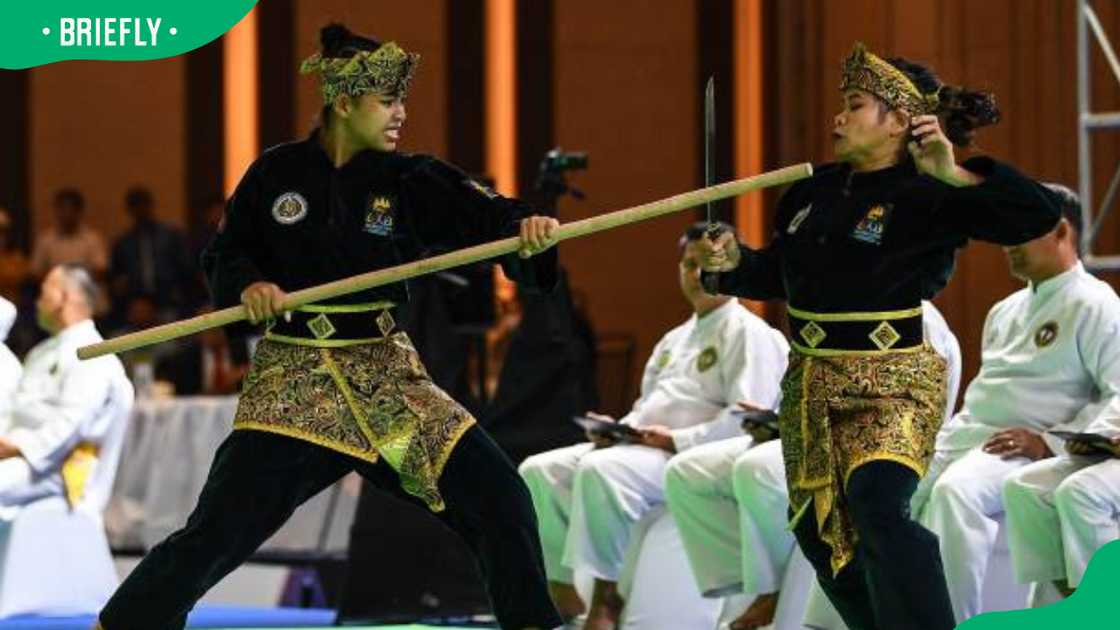 Cambodia's Alfas Jan Asmael Abad (L) and Almohaidip Esmael Abad (R) during Silat games