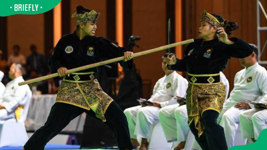 Cambodia's Alfas Jan Asmael Abad (L) and Almohaidip Esmael Abad (R) during Silat games Cambodia's Alfas Jan Asmael Abad (L) and Almohaidip Esmael Abad (R) during Silat games