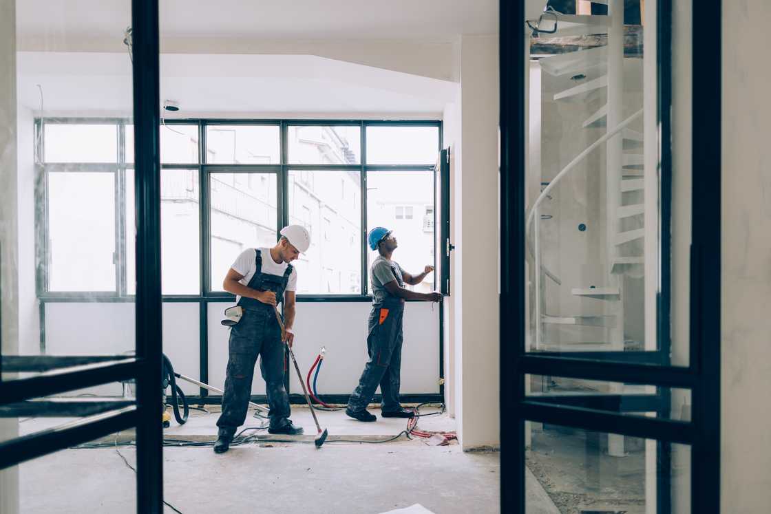 A stock photo of construction workers on duty in an apartment A stock photo of construction workers on duty in an apartment