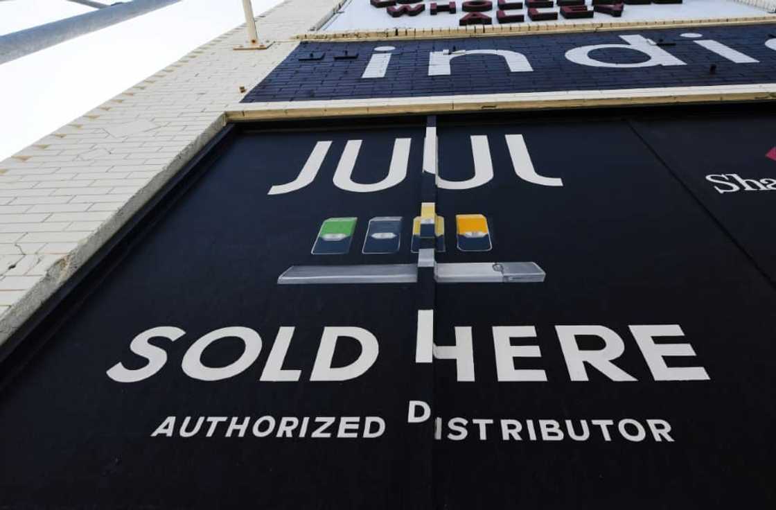 (FILES) In this file photo taken on September 17, 2019 a sign advertises Juul vaping products in Los Angeles, California