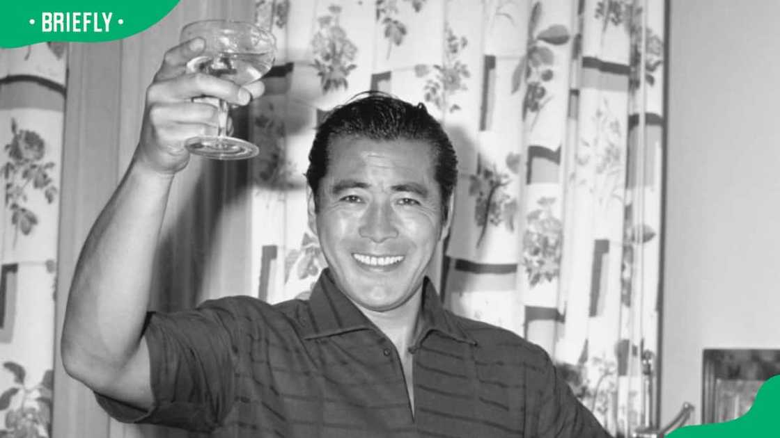 The famous Japanese actor, Toshiro Mifune raising a glass The famous Japanese actor, Toshiro Mifune raising a glass