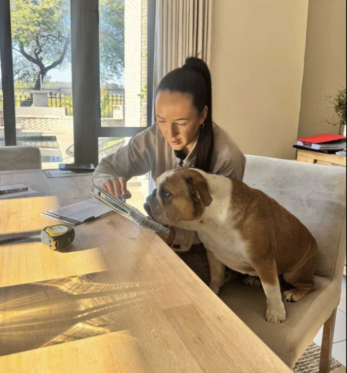 A South African property flipper pictured with her pet dog A South African property flipper pictured with her pet dog