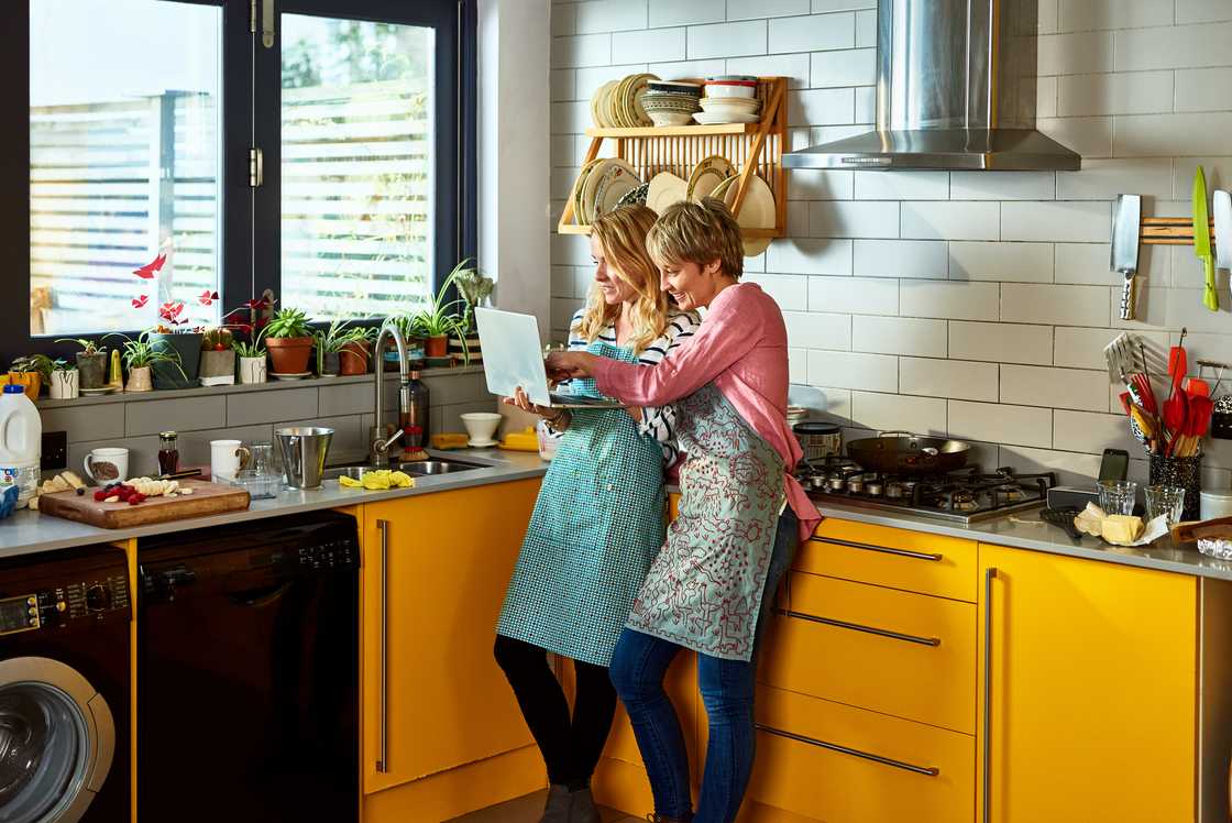 Two women in a kitchen. Two women in a kitchen.
