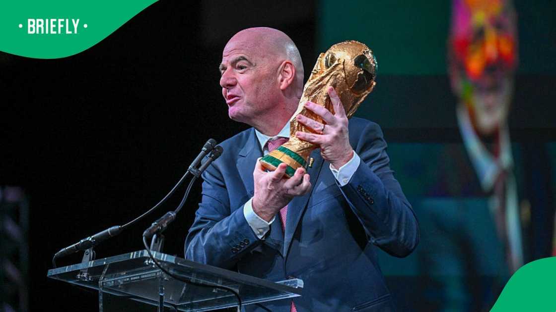 Gianni Infantino holding FIFA World Cup trophy Gianni Infantino holding FIFA World Cup trophy