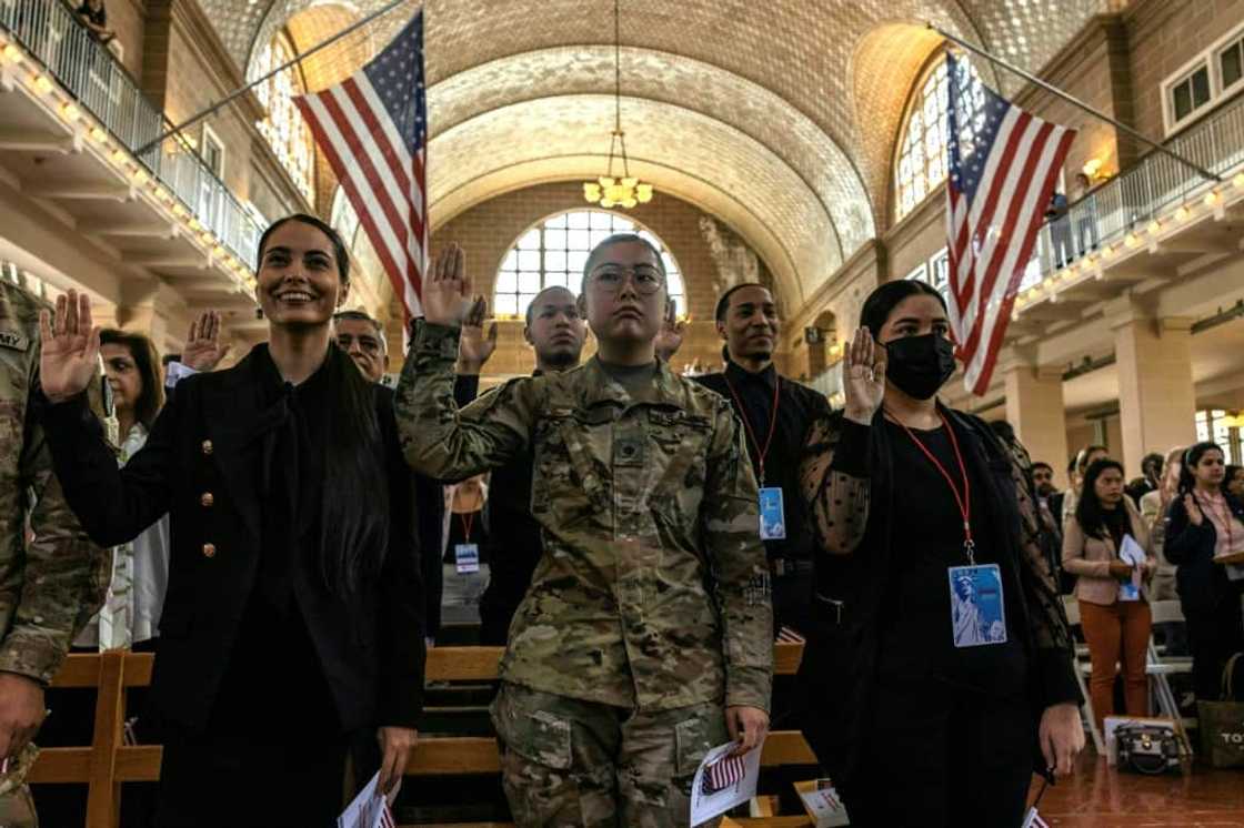 New US citizens take the oath during a naturalization service on Ellis Island, a highly symbolic spot for the ceremony