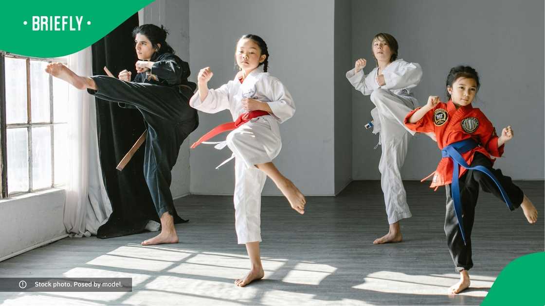 A group of people doing martial arts. A group of people doing martial arts.