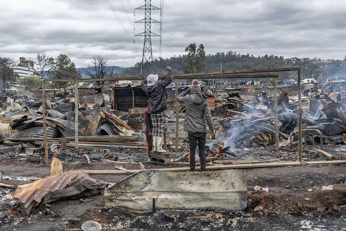 Residents try to rebuild their shacks after a fire destroyed more than 500 structures at the Jika Joe informal settlement in Pietermaritzburg, KwaZulu-Natal, August 11, 2026