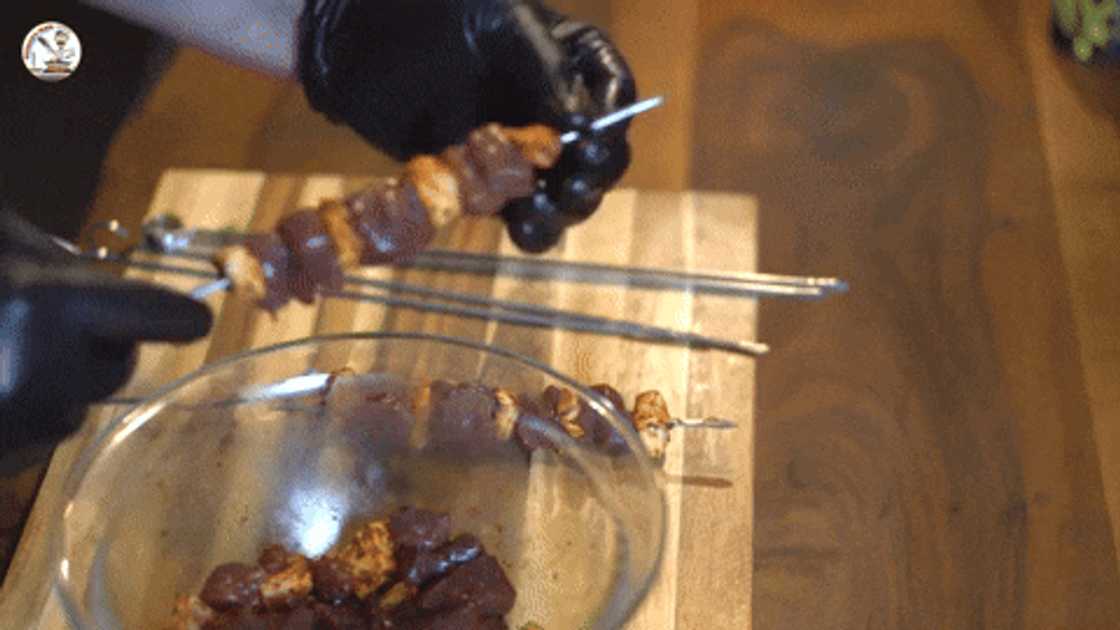 Placing liver pieces on skewers Placing liver pieces on skewers