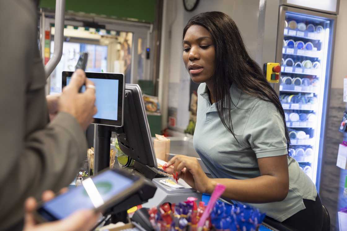 a woman in a shop serving customers
