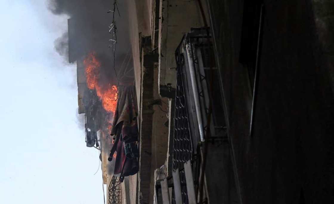 Flames pour out of a blazing building in Gaza City following an Israeli air strike Flames pour out of a blazing building in Gaza City following an Israeli air strike