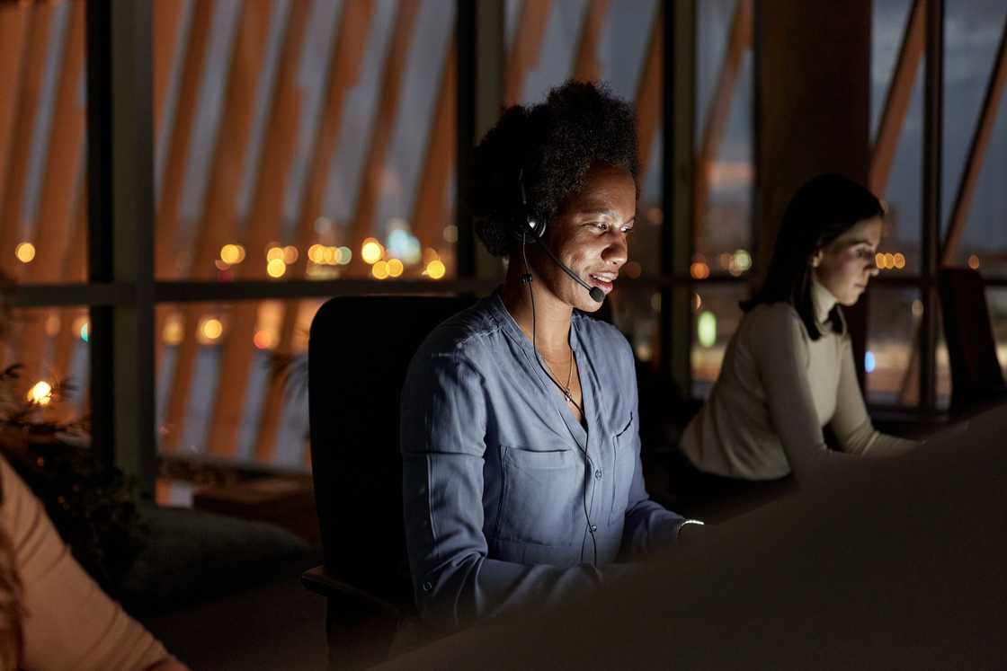 A call centre agent listens during a long, late-night call.