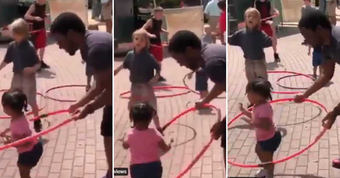 Father helps daughter hula-hoop in cute clip Father helps daughter hula-hoop in cute clip