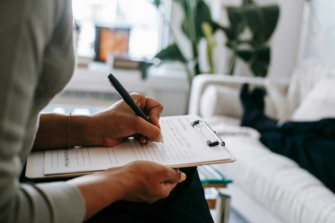 A person filling a form A person filling a form