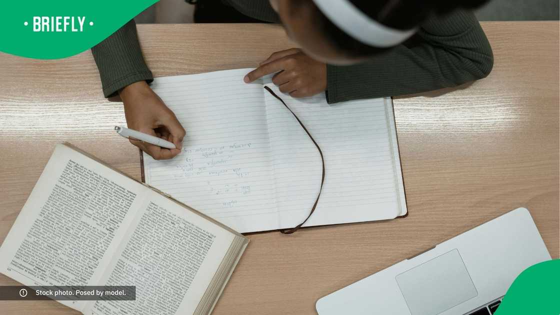 A learner writing notes.