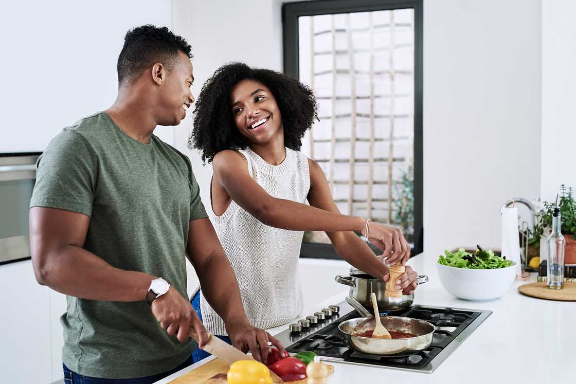 A couple cooks dinner together