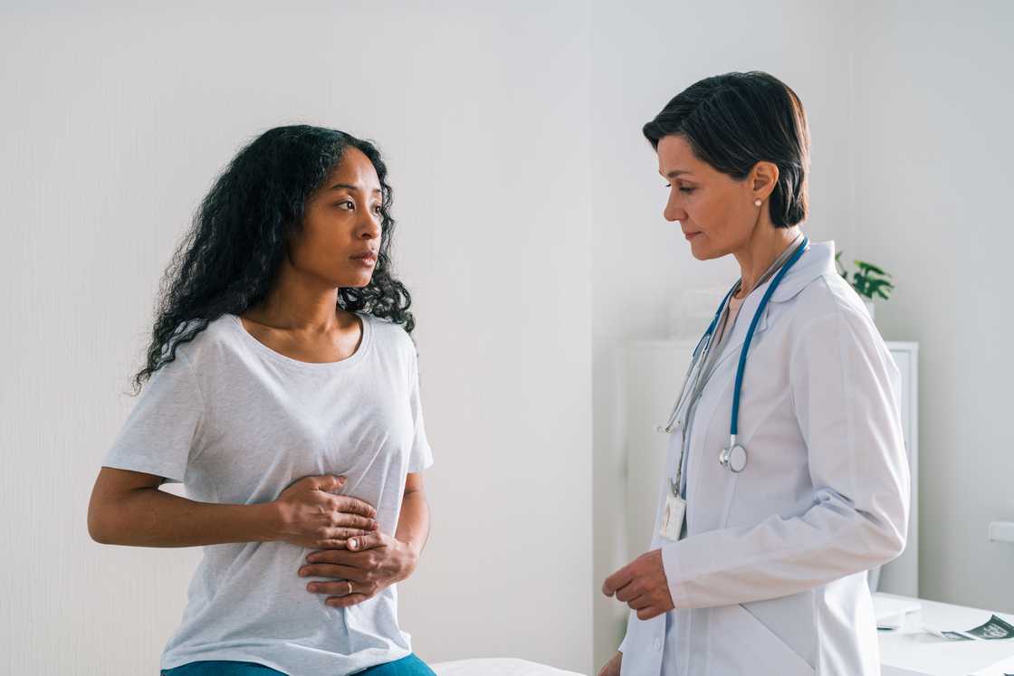 A lady is at the hospital being examined by a doctor