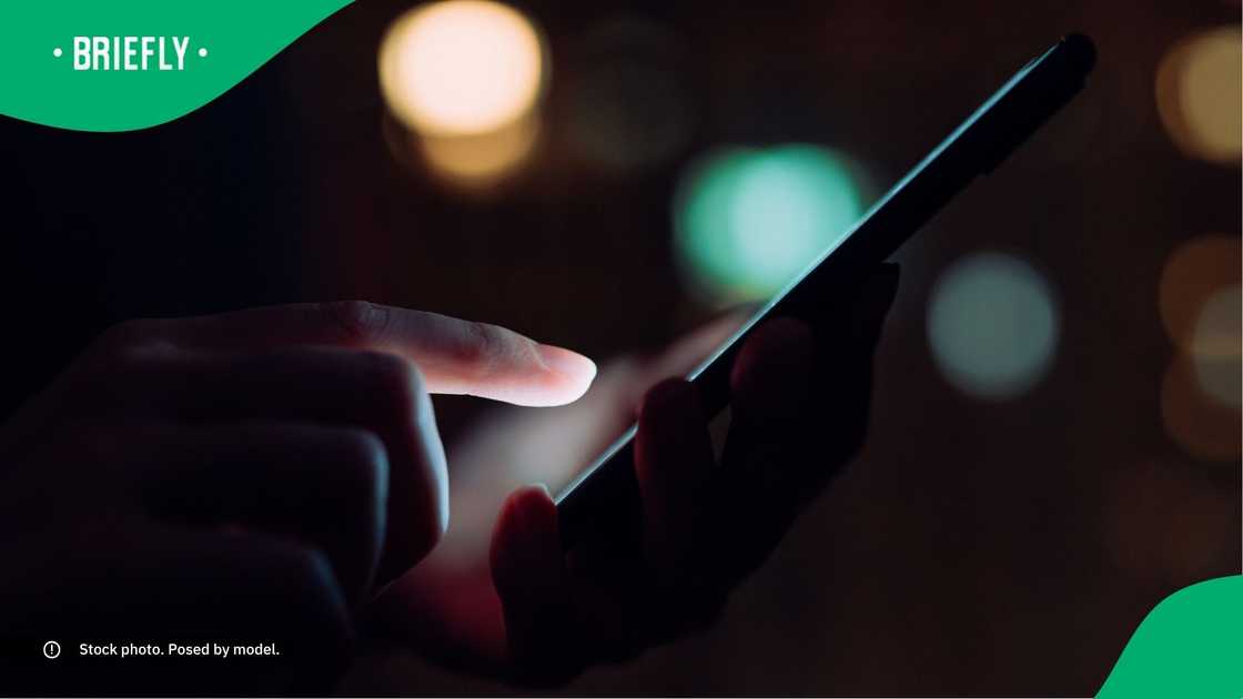 A person typing on their phone. A person typing on their phone.