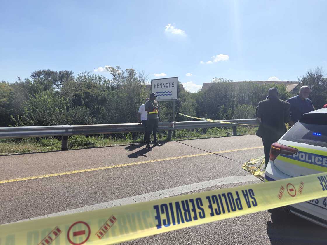 The police continue to comb the crime scene at Hennops River to find the missing VW Polo The police continue to comb the crime scene at Hennops River to find the missing VW Polo