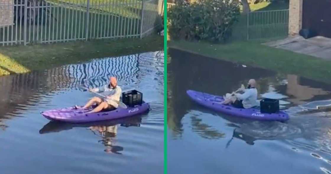 A man was kayaking down a flooded street A man was kayaking down a flooded street