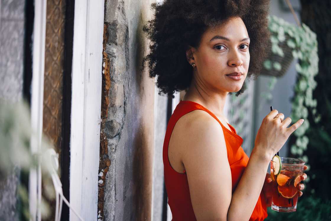 A woman holding a drink