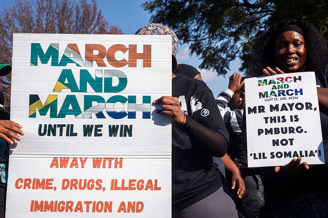Women hold signs when demonstrating against illegal immigration during a protest organized by March and March, a grassroots citizen movement, on June 19, 2026 in Pietermaritzburg, South Africa Women hold signs when demonstrating against illegal immigration during a protest organized by March and March, a grassroots citizen movement, on June 19, 2026 in Pietermaritzburg, South Africa