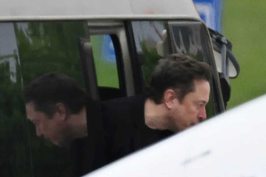 Tesla CEO Elon Musk gets off a minibus before boarding his private plane at Beijing airport