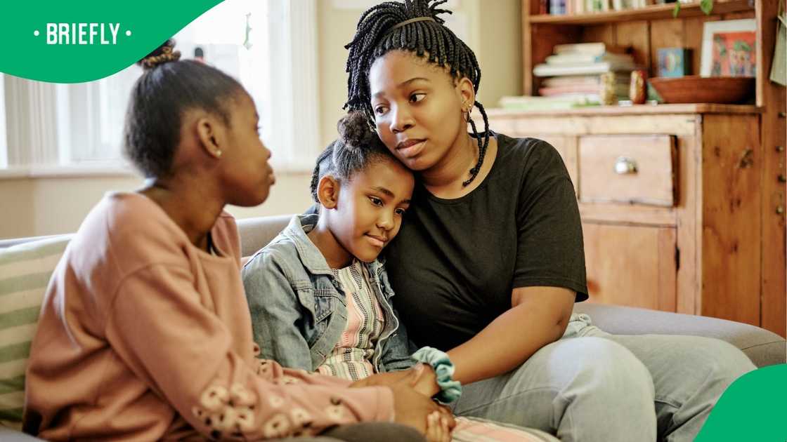 A stock photo of a mom with her unhappy kids in the living room A stock photo of a mom with her unhappy kids in the living room