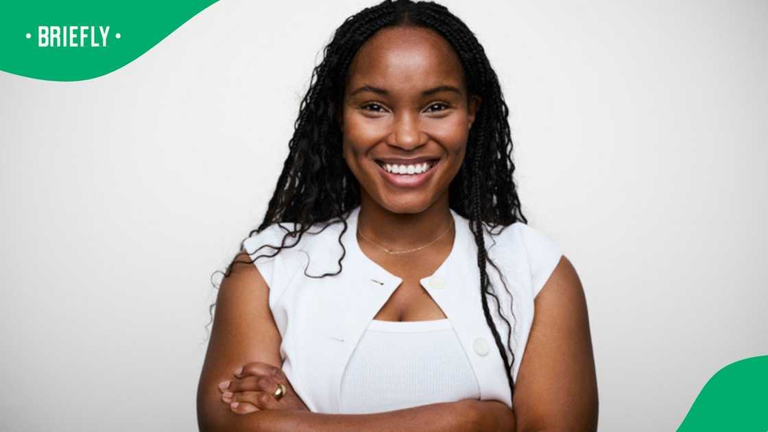 An African woman with long hair smiles.