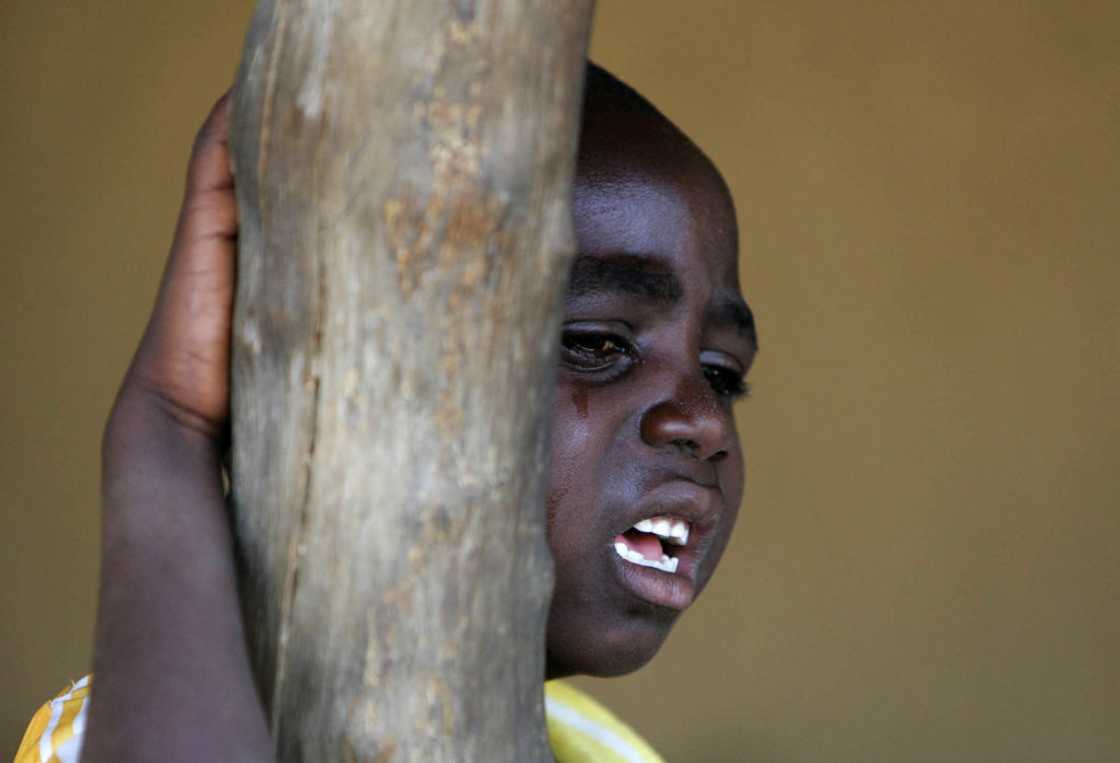 A schoolboy cries outside