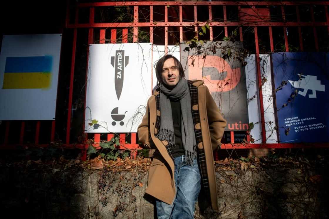 Ukrainian graphic designer Mykola Kovalenko with some of his posters in Bratislava, Slovakia Ukrainian graphic designer Mykola Kovalenko with some of his posters in Bratislava, Slovakia