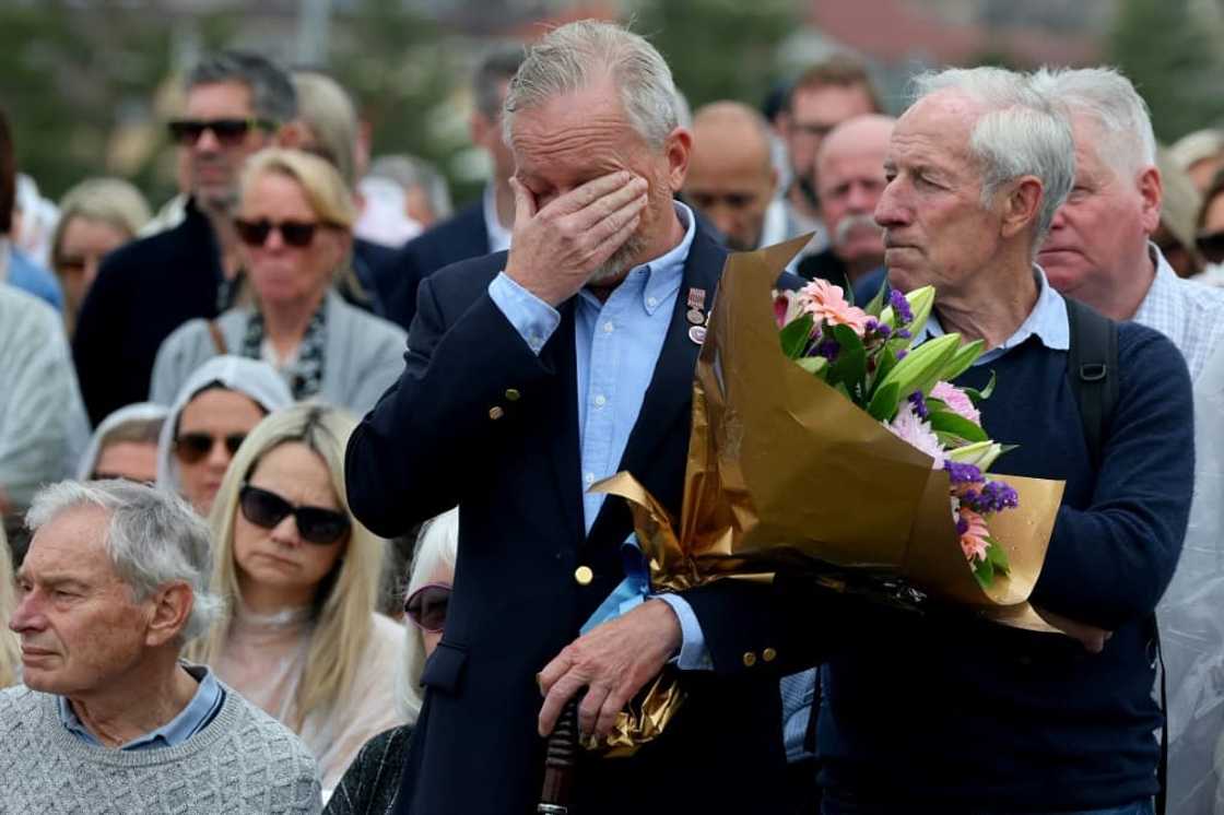 People attend a commemoration ceremony to mark the 20th anniversary of the Bali bombings at Sydney's Coogee Beach People attend a commemoration ceremony to mark the 20th anniversary of the Bali bombings at Sydney's Coogee Beach