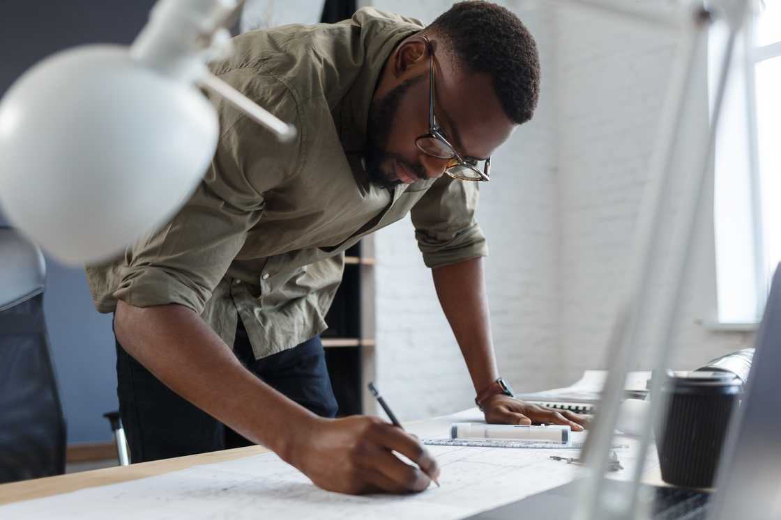 An architect working with blueprints. An architect working with blueprints.