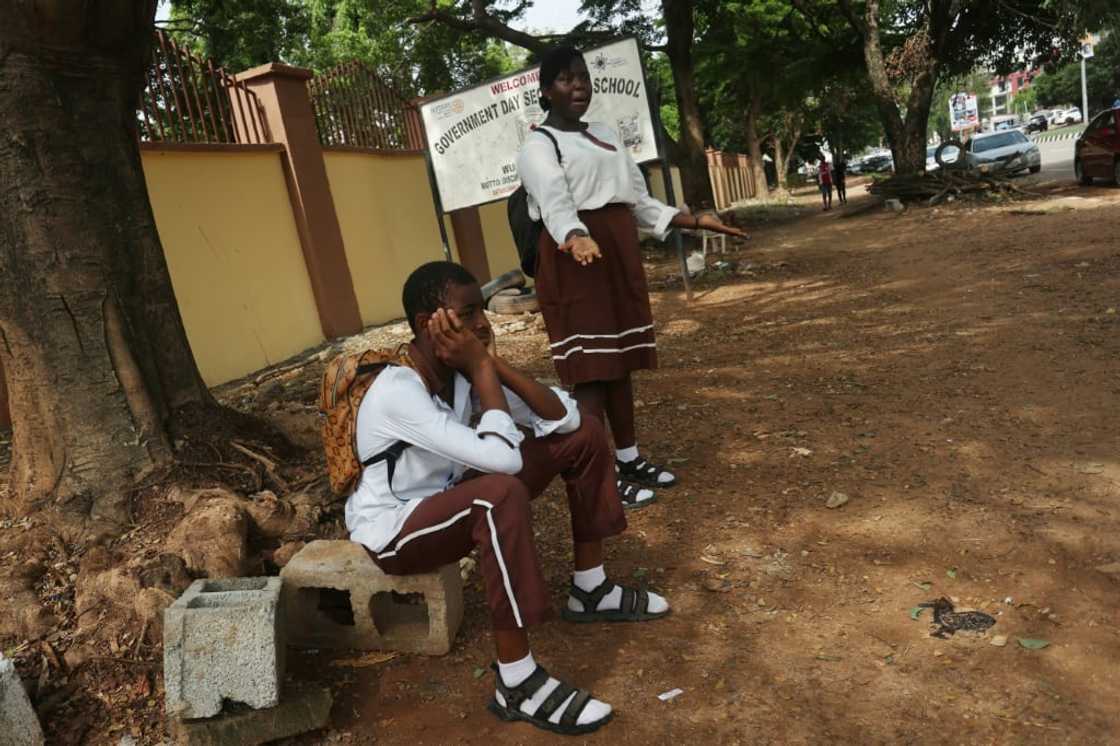 Students wait outside their Government Science Secondary School in the capital after unions launched an indefinite strike for a higher minimum wage