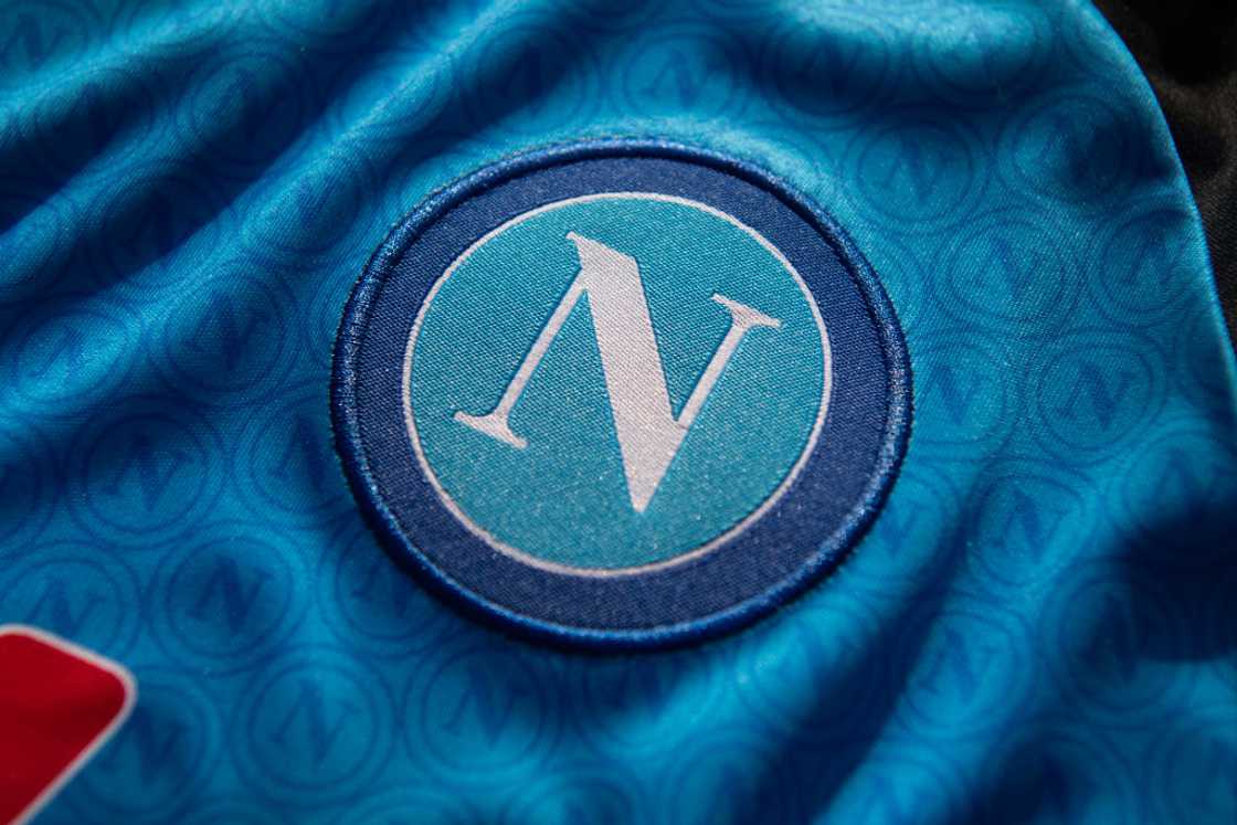 The official SSC Napoli football club badge on a home shirt The official SSC Napoli football club badge on a home shirt