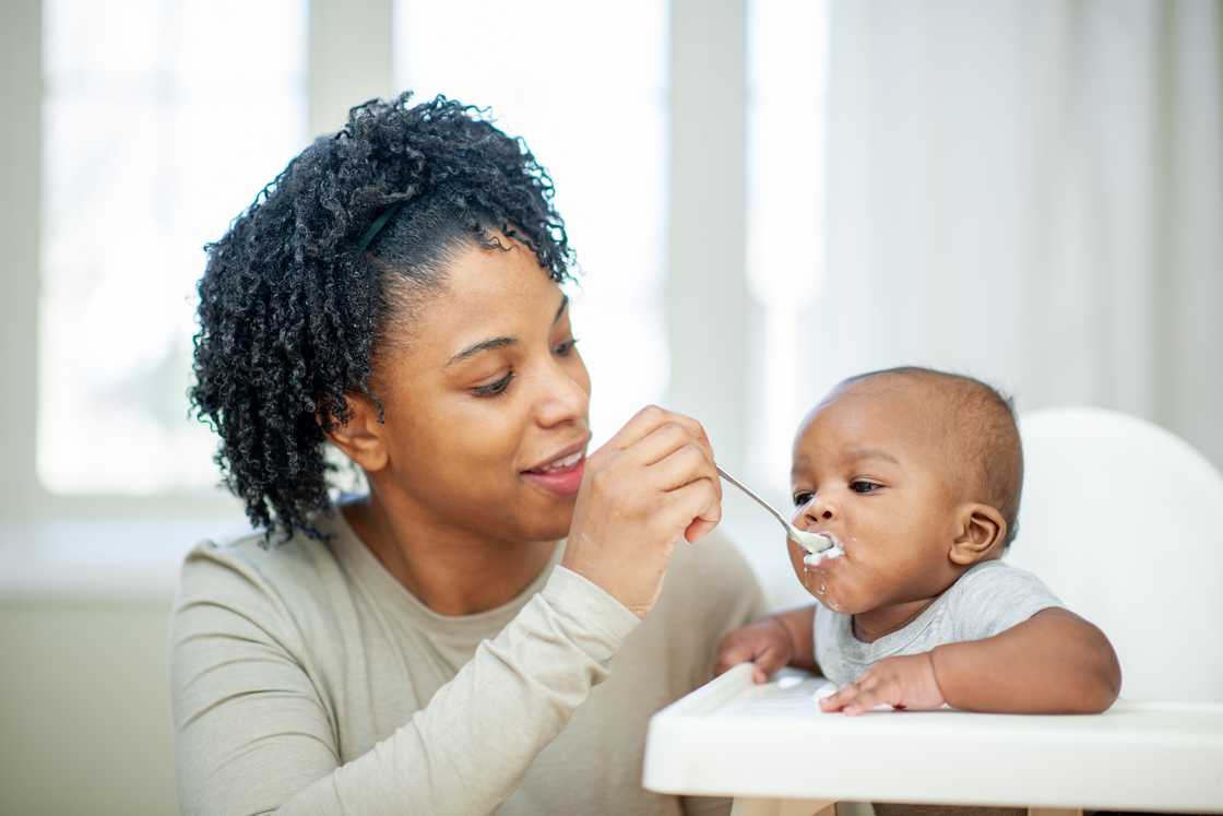 A mother feeding her child.