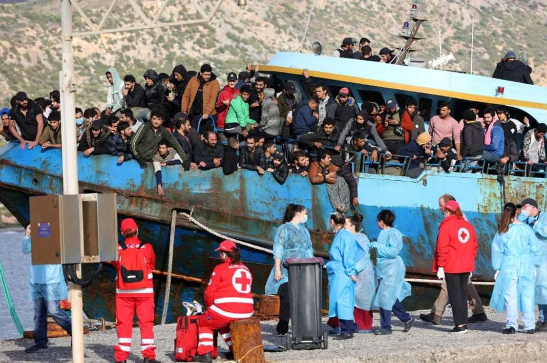 Hellenic Red Cross rescuers and health workers readied to help passengers disembark Hellenic Red Cross rescuers and health workers readied to help passengers disembark