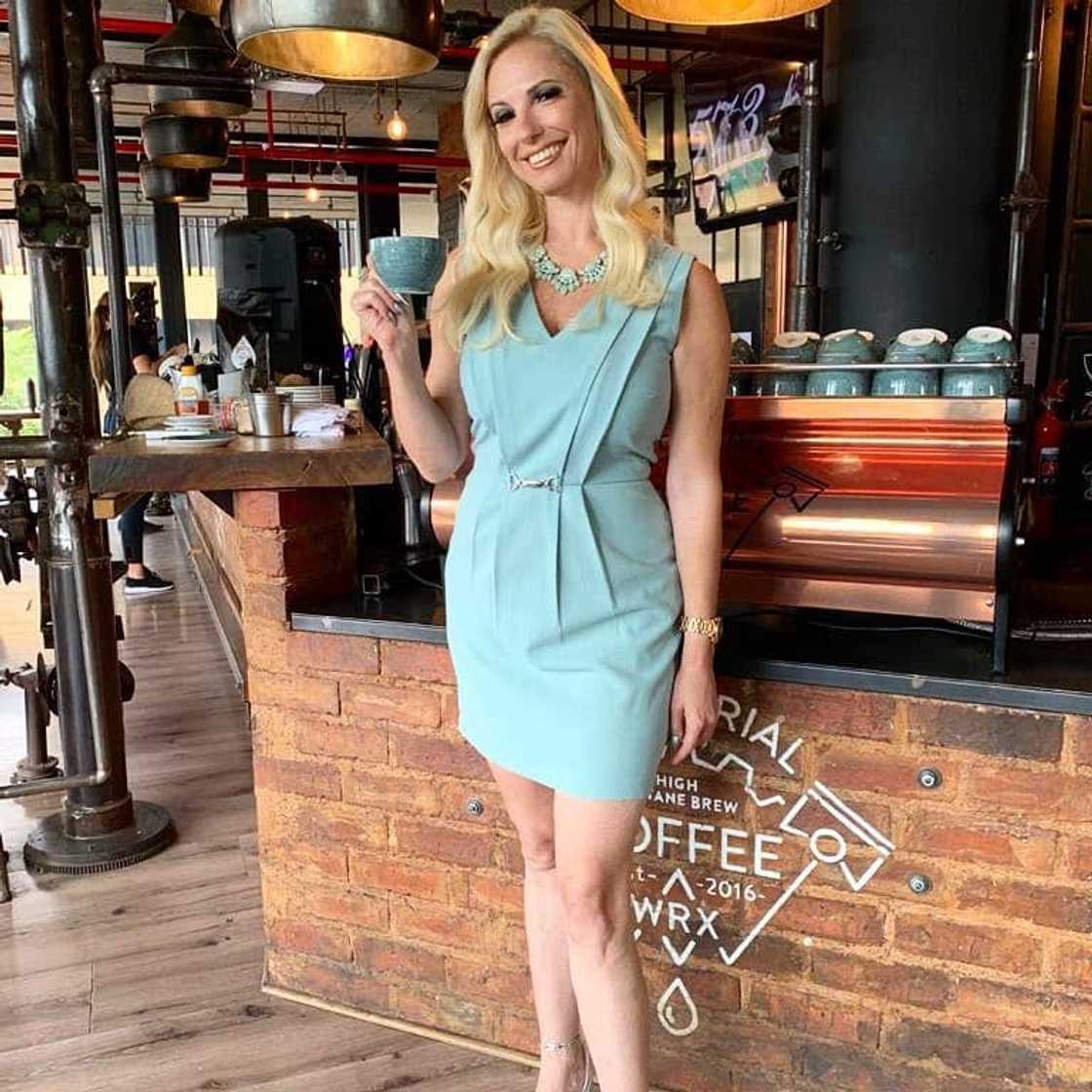 Christall Kay posing for a photo in a restaurant Christall Kay posing for a photo in a restaurant