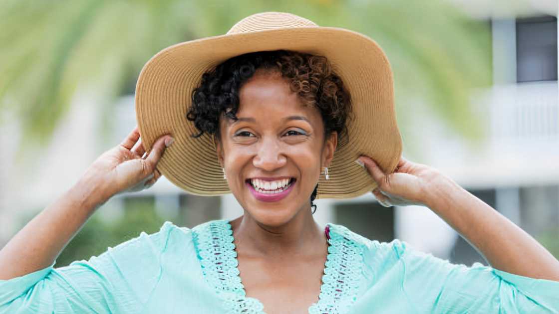 A woman wearing a wide brim sun hat.