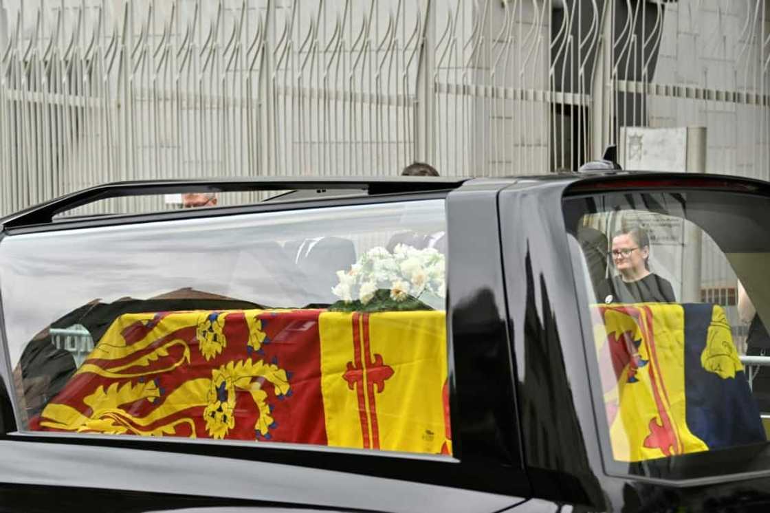 The hearse carrying the coffin of Queen Elizabeth II, draped in the Royal Standard of Scotland, is driven through Edinburgh towards the Palace of Holyroodhouse, on September 11, 2022 The hearse carrying the coffin of Queen Elizabeth II, draped in the Royal Standard of Scotland, is driven through Edinburgh towards the Palace of Holyroodhouse, on September 11, 2022